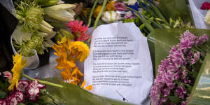 A message left for the victims among the flowers.