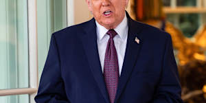 President Donald Trump accepts a bag of McDonald’s from a delivery worker at the White House.