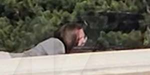 A screen grab from a video shot by a bystander and sourced by celebrity website TMZ shows the shooter – Thomas Matthew Crooks – on a rooftop.