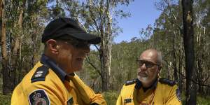 RFS District Officers Steve Farrell and Stuart Robb inspect a map of the Lindfield Park Road fire,which has been burning since last July.