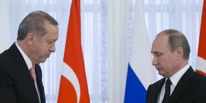 All good now? Russian President Vladimir Putin,right,and Turkish President Recep Tayyip Erdogan shake hands during a news conference.