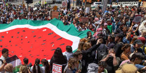 Protesters hold a watermelon flag in Melbourne at the School Strike for Palestine rally on November 23. Watermelons,which have the same the colours as the Palestinian flag,are used as symbols of Palestinian resistance.