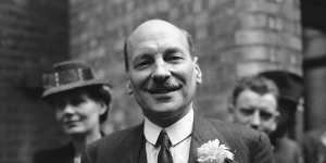 Britain’s postwar PM Clement Attlee smiles at a cheering crowd in London in July 1945.