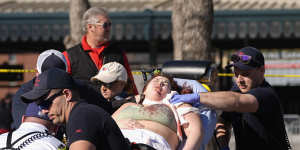 A person is taken to an ambulance following a shooting at the Kansas City Chiefs NFL football Super Bowl celebration.