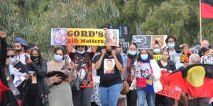 Crowds walk through the streets of Moree in July,nearly three weeks after Gordon vanished.