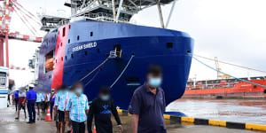 Sri Lankan men are led off the Australian Border Force ship Ocean Shield in Colombo in August.