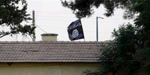 An Islamic State flag flies over the custom office of Syria's Jarablus border gate,pictured from the Turkish town of Karkamis.