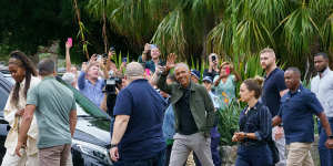 Barack Obama waves to onlookers after leaving Bathers’ Pavilion restaurant in Balmoral on Monday.