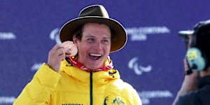 Bronze medallist Ben Tudhope of Team Australia celebrates on the podium during the medal ceremony for the Para Snowboard Men’s Banked Slalom SB-LL2.