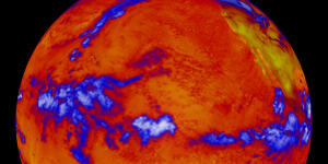 A false-colour image from 2001 showing where more or less heat,measured in long-wave radiation,was emanating. The thermal radiation leaving the oceans is fairly uniform. The blue represent thick clouds,the top of which are cold.