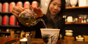 Founder of Ms. Cattea Cathy Zhang prepares Nine Mountains green tea on a candle burner.