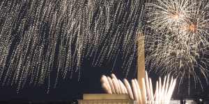 Fourth of July fireworks explode over the Lincoln Memorial,the Washington Monument and the US Capitol,along the National Mall in Washington.