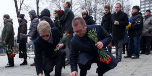 Men place candles as they arrive at a farewell ceremony to slain opposition leader Boris Nemtsov in Moscow on Monday.