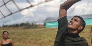 FARC rebel David,who lost his arm following wounds suffered in a firefight,plays volleyball in the Yari plains.