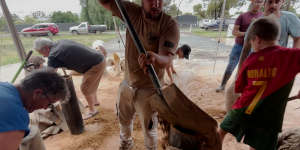 Residents fill sand bags as flood water rises