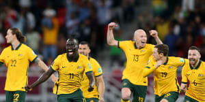 The Socceroos erupt with joy.