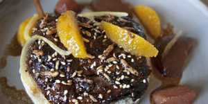 Sticky,pull-apart braised duck leg sits on a puck of cracked wheat.