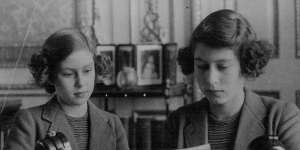 Princess Elizabeth with her script for her first radio broadcast,aged 14,on October 13,1940. On the left is her younger sister,Princess Margaret.