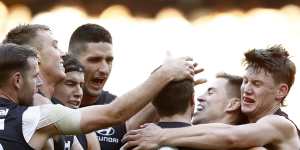 Former skipper Marc Murphy celebrates a goal with his Blues teammates in their clash with the Hawks.