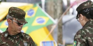Soldiers help clear out an encampment set up by supporters of Bolsonaro.