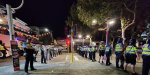 Police in Northbridge work to disperse crowds late on Australia Day.