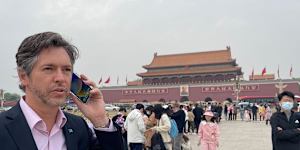 Lord Mayor Nick Reece in China last month. On his mobile phone.