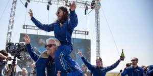Virgin Galactic founder Richard Branson carries crew member Sirisha Bandla on his shoulders while celebrating their flight to space in July.