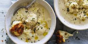 Creamy cauliflower cheese soup pictured with pieces of parmesan and thyme monkey bread (see recipe below).