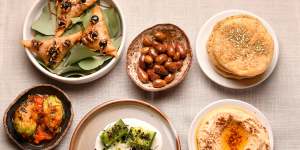 The opening flurry of snacks starring Turkish breads,hummus,and arak cucumbers.
