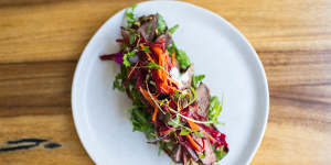 Lamb and haloumi open rye with beetroot slaw.
