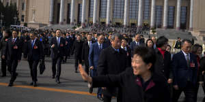 Delegates leave the Great Hall of the People after attending a preparatory session of the National People’s Congress in Beijing on Tuesday.