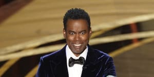 Chris Rock on stage presenting the award for best documentary feature at the 2022 Oscars.