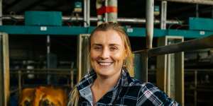 Tess Butler in the milking shed on her dairy farm in West Gippsland,Victoria. 
