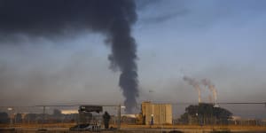 Smoke rises from an oil tank on fire after it was hit by a rocket from Gaza,near the Israeli town of Ashkelon,Israel.