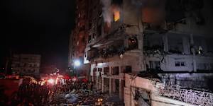 Smoke pours from a building after it was hit by Israeli airstrikes in the Al-Remal area in Gaza City.