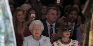 Queen Elizabeth sits next to Vogue’s Anna Wintour as they view Richard Quinn’s runway show before presenting him with the inaugural Queen Elizabeth II Award for British Design in 2018.