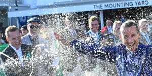 Damien Oliver is sprayed with champagne.