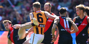 James Sicily of the Hawks gives away a free kick to Andrew McGrath of the Bombers.