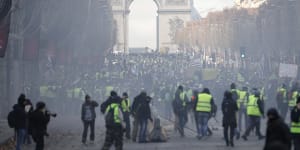 A cloud of tear gas fills the air on the streets of Paris. 
