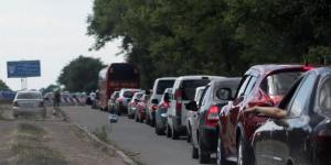 Cars queue at a checkpoint as people flee the southern Ukrainian city of Mariupol amid fears of an attack by pro-Russian militants.