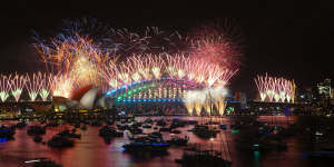 Sydney Harbour Bridge lights up with fireworks on New Year’s Eve.