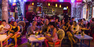Spruikers lure visitors with cheap beer and massive menus on Bui Vien Walking Street.