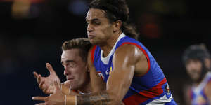 Ben Paton of the Saints competes with Jamarra Ugle-Hagan of the Bulldogs during the round two.