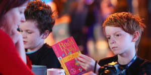 A young boy reads a copy of Roald Dahl’s book Matilda ahead of the launch of Matilda the musical.