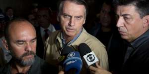Presidential candidate Jair Bolsonaro,with the Social Liberal Party,talks to the press after visiting Federal Police headquarters in Rio de Janeiro,.