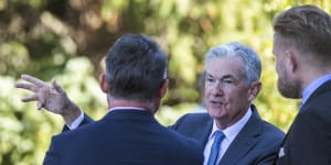 Federal Reserve Chair Jerome Powell,center,takes a coffee break with attendees of the central bank’s annual symposium at Jackson Hole.