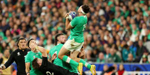 PARIS,FRANCE - OCTOBER 14:Hugo Keenan of Ireland wins the ball as Jordie Barrett of New Zealand falls to the ground during the Rugby World Cup France 2023 Quarter Final match between Ireland and New Zealand at Stade de France on October 14,2023 in Paris,France. (Photo by Warren Little/Getty Images)