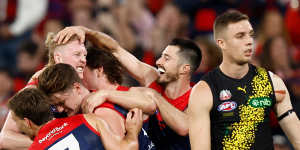 Clayton Oliver celebrates a crucial goal with his Melbourne teammates.