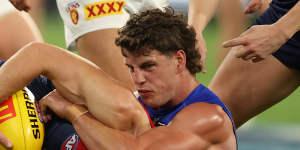 Jack Viney of the Demons tackled by Jarrod Berry of the Lions.