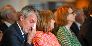 Attorney-General Mark Dreyfus (left) wipes away tears.